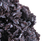 A large, impressive mineral specimen featuring a dense coverage of shiny, dark reddish-brown to black descloizite crystals in distinctive spearhead formations. The crystals, which show amber translucency, are arranged in a complex, overlapping pattern across the entire surface of the specimen. The piece is roughly triangular in shape when viewed from above, with the crystals forming dramatic, three-dimensional projections that create a textured, sculptural appearance.