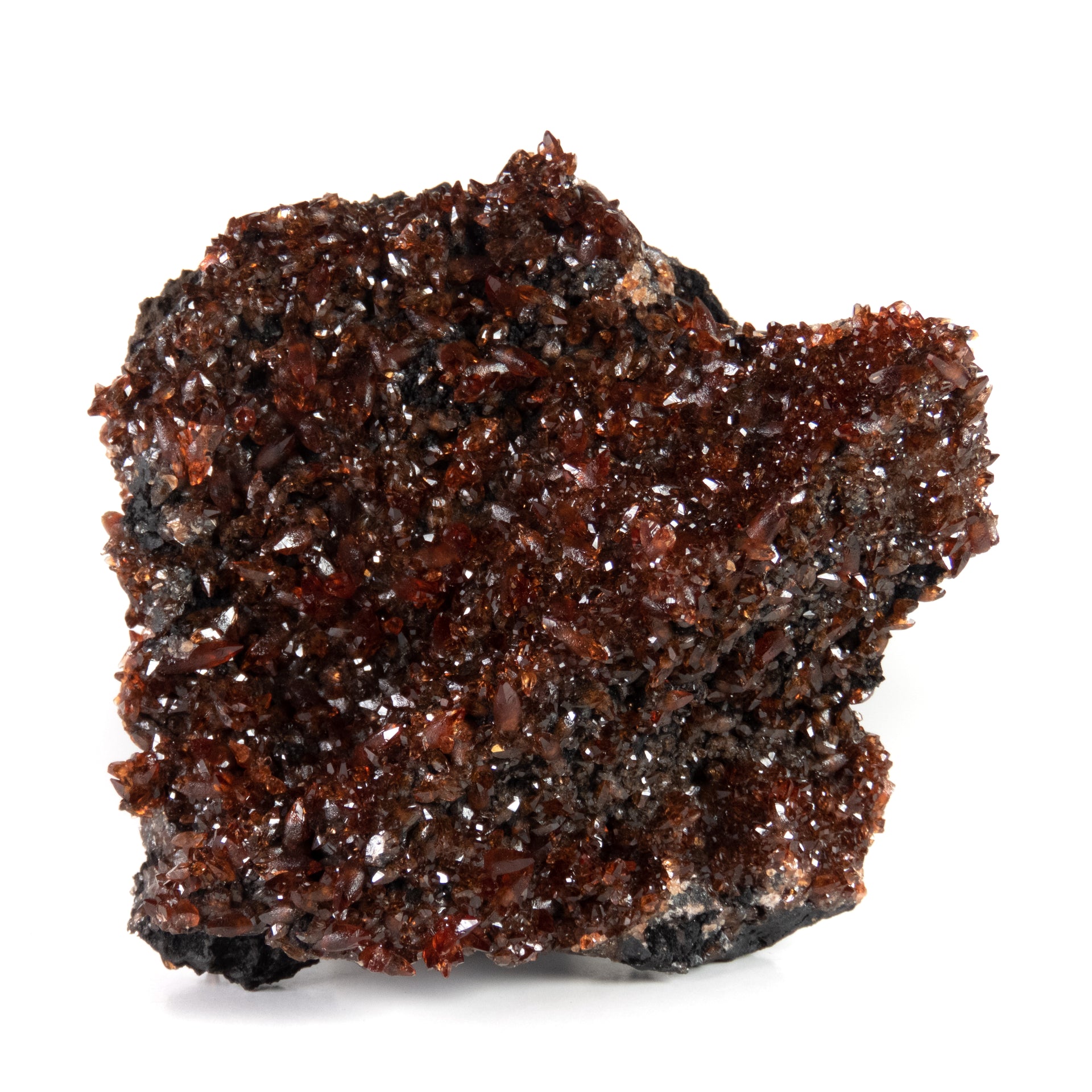 A remarkable rhodochrosite specimen featuring sharp scalenohedral crystals with deep cherry-red to orange coloration and exceptional gemmy transparency. The 7 cm specimen from Gabon's scarce Moanda Mine displays brilliant surface luster, complete coverage, and represents a superior example from this historic African locality.
