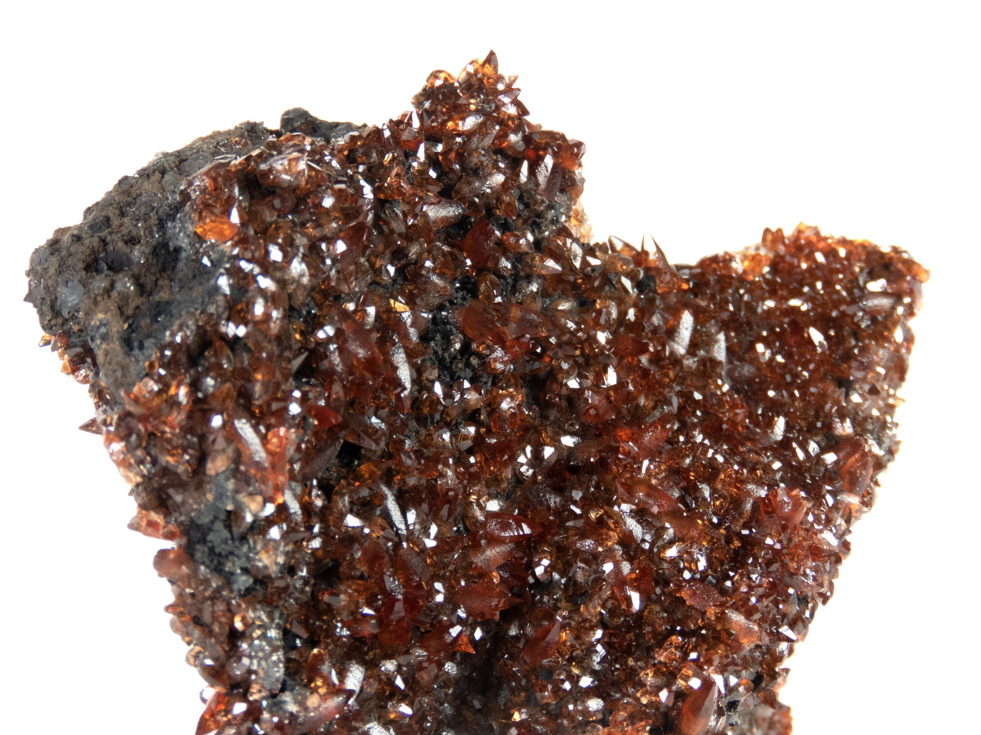 A remarkable rhodochrosite specimen featuring sharp scalenohedral crystals with deep cherry-red to orange coloration and exceptional gemmy transparency. The 7 cm specimen from Gabon's scarce Moanda Mine displays brilliant surface luster, complete coverage, and represents a superior example from this historic African locality.