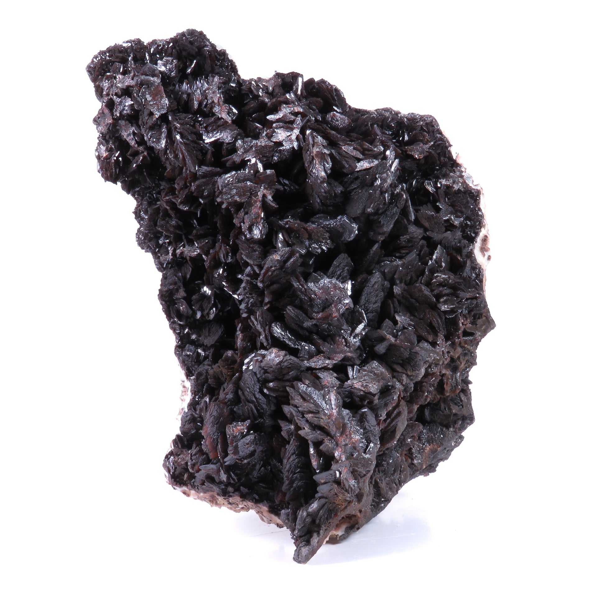 A large, impressive mineral specimen featuring a dense coverage of shiny, dark reddish-brown to black descloizite crystals in distinctive spearhead formations. The crystals, which show amber translucency, are arranged in a complex, overlapping pattern across the entire surface of the specimen. The piece is roughly triangular in shape when viewed from above, with the crystals forming dramatic, three-dimensional projections that create a textured, sculptural appearance.