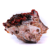 Tons of bright red vanadinite blades, together with tons of sharp light barite blades, with another darker mineral coating much of the latter. Fantastic visuals!