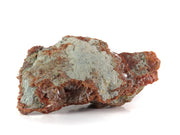 A striking mineral specimen featuring transparent, tabular celestine crystals jutting out from a rusty-red hematite-stained matrix. The crystals are glassy and well-formed, arranged in a bristling formation across the specimen's surface. The dramatic contrast between the clear, prismatic crystals and the deep red-brown matrix creates a natural sculptural effect.