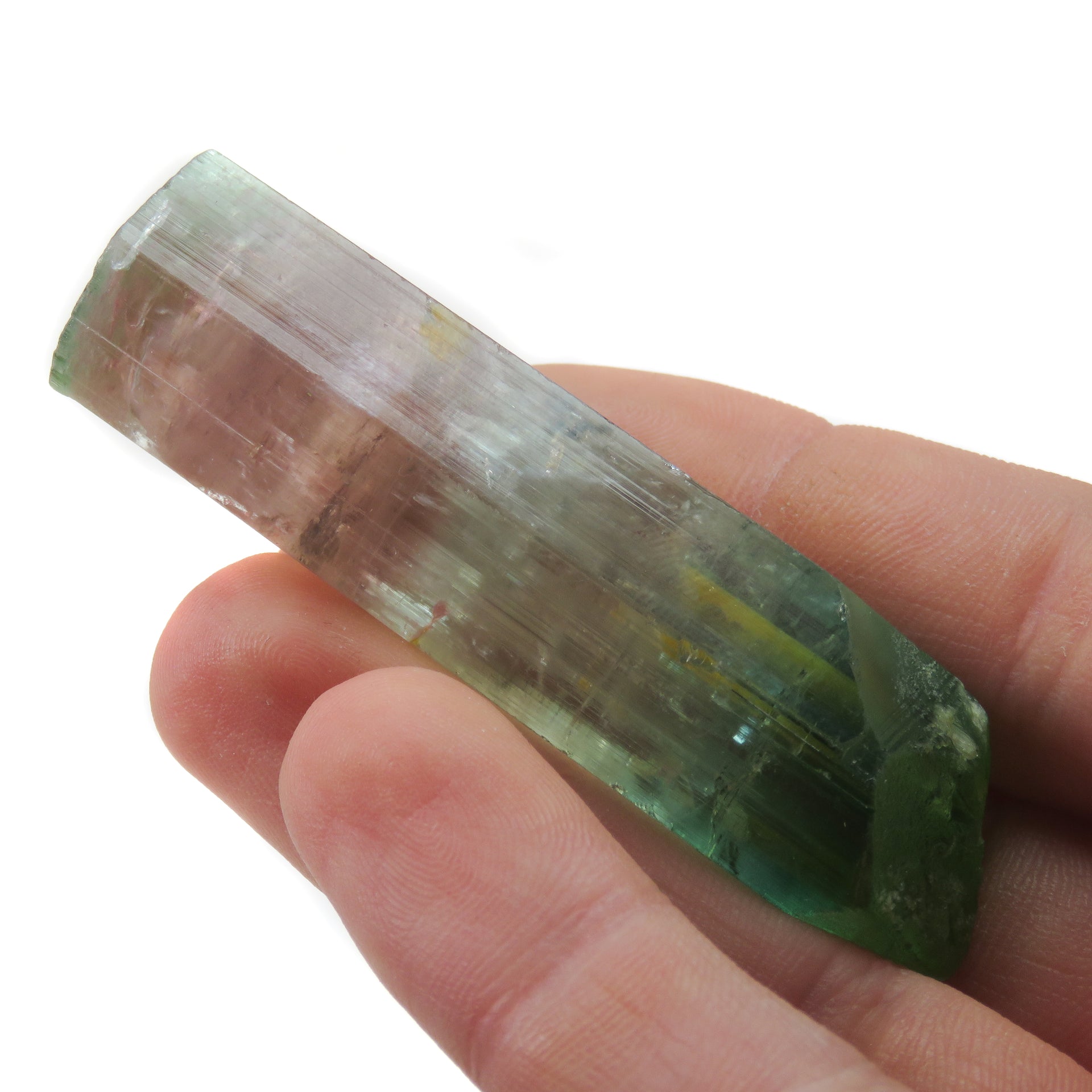A superior Nigerian tourmaline specimen featuring a large doubly-terminated floater crystal with dramatic color zoning from vibrant green through gem-clear achroite to blue-green and rich pink sections. The remarkable crystal displays exceptional transparency, pristine terminations, and a complex progression of colors that make it a significant example of the latest finds from this prolific locality.