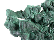 A superior malachite pseudomorph specimen featuring expansive crystal replacements with velvety texture and varied green hues. The 12 cm plate from Mexico's Milpillas Mine displays exceptional preservation of original azurite forms, striking dimensional presentation, and represents classic material from this world-class locality.