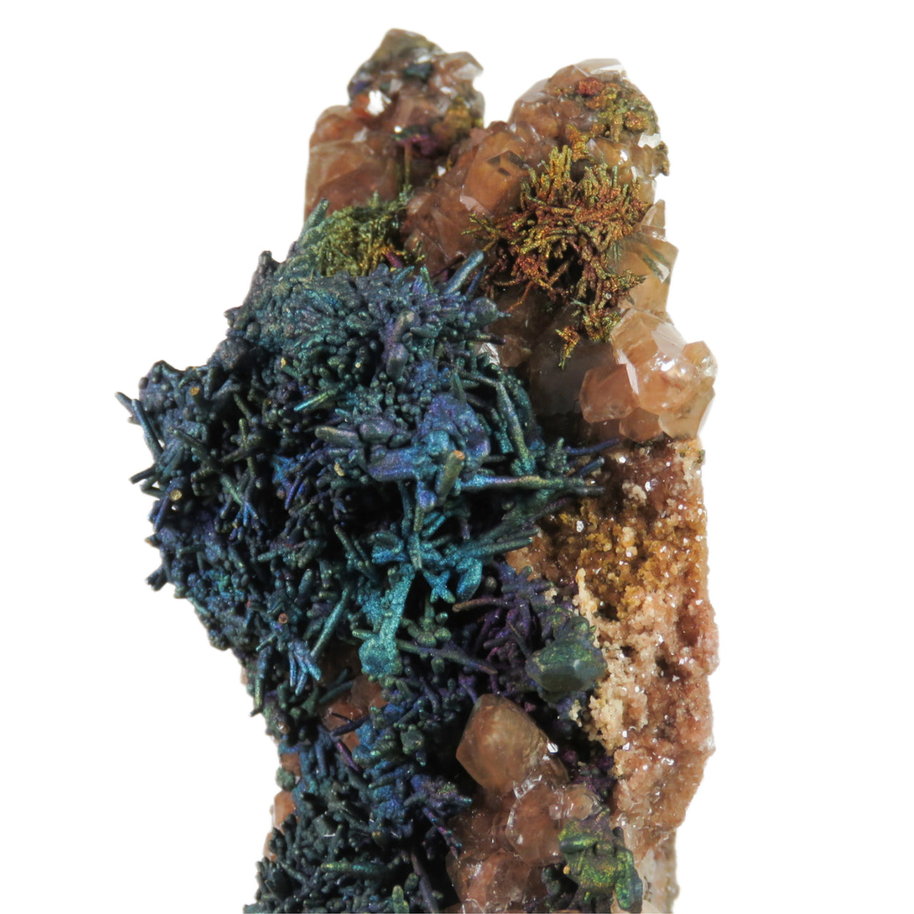 A dramatic, tower-like mineral specimen featuring iridescent blue-green chalcopyrite forming organic, tendril-like patterns across the surface. Orange-red calcite crystals are scattered throughout, creating striking contrast against the metallic sulfide minerals. The specimen's unusual formation creates a sculptural presence, with layered minerals building up to create a distinctive vertical form.