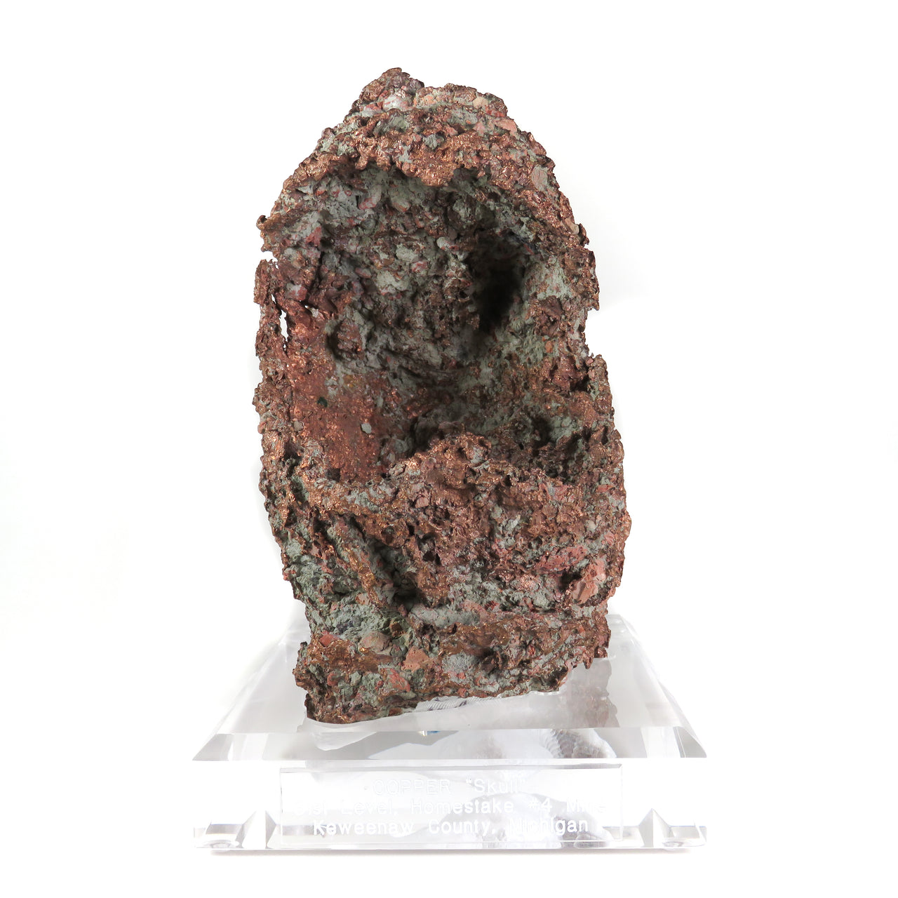 A remarkable native copper specimen featuring a rare skull-cast formation with medieval helmet-like shape and intricate surface patination. The exceptional specimen from Michigan's Centennial Mine displays complete preservation, historic Kennedy collection provenance, and represents one of the finest examples of this unique copper growth phenomenon.