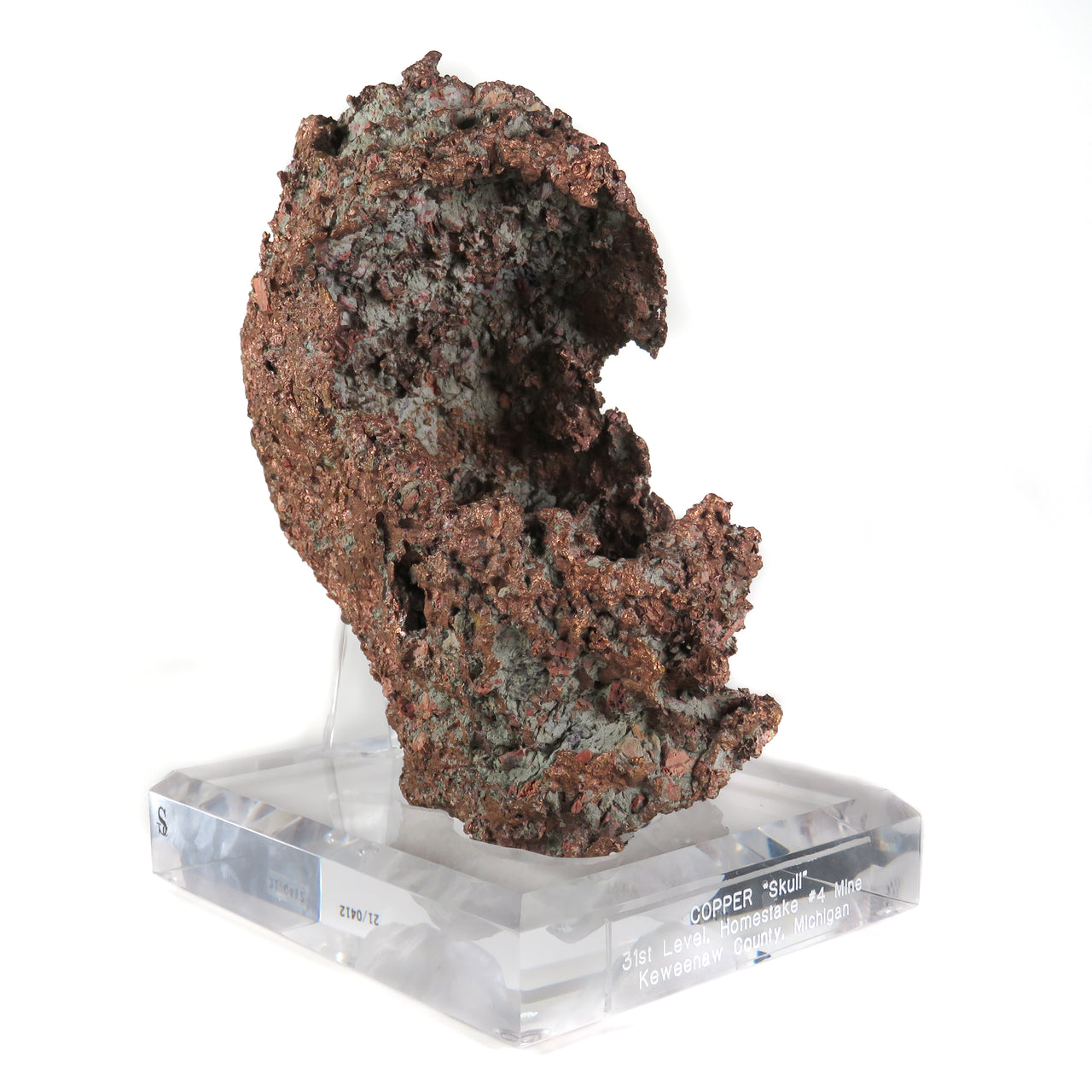 A remarkable native copper specimen featuring a rare skull-cast formation with medieval helmet-like shape and intricate surface patination. The exceptional specimen from Michigan's Centennial Mine displays complete preservation, historic Kennedy collection provenance, and represents one of the finest examples of this unique copper growth phenomenon.