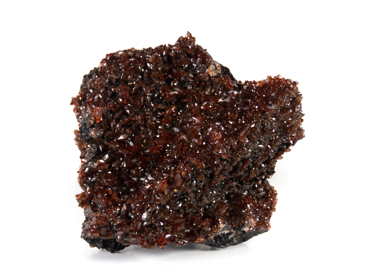 A remarkable rhodochrosite specimen featuring sharp scalenohedral crystals with deep cherry-red to orange coloration and exceptional gemmy transparency. The 7 cm specimen from Gabon's scarce Moanda Mine displays brilliant surface luster, complete coverage, and represents a superior example from this historic African locality.