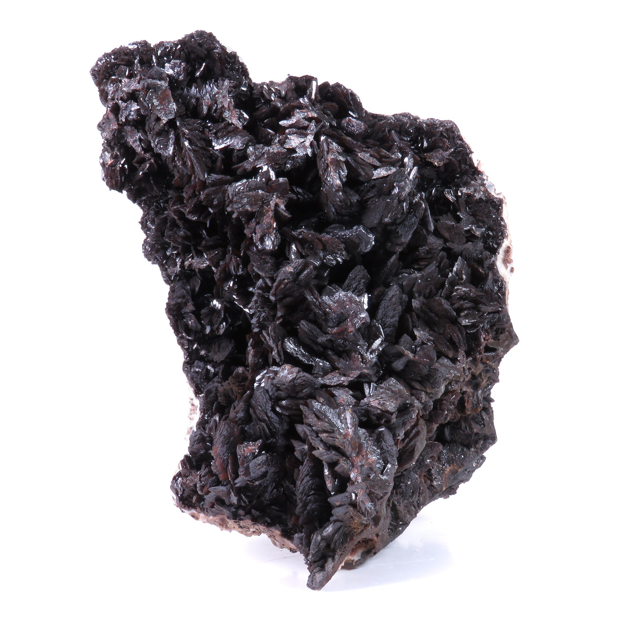 A large, impressive mineral specimen featuring a dense coverage of shiny, dark reddish-brown to black descloizite crystals in distinctive spearhead formations. The crystals, which show amber translucency, are arranged in a complex, overlapping pattern across the entire surface of the specimen. The piece is roughly triangular in shape when viewed from above, with the crystals forming dramatic, three-dimensional projections that create a textured, sculptural appearance.