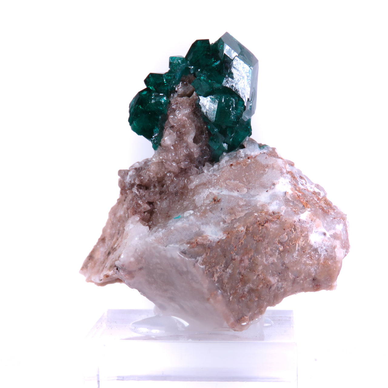 Two views of a mineral specimen featuring deep emerald-green dioptase crystals perched on pale pink-brown quartz matrix. The dioptase forms a cluster of well-formed, prismatic crystals with the largest crystal reaching nearly an inch in length. The crystals are highly translucent with glassy luster, showing bright reflective faces, particularly visible in the second, closer view. The main crystal displays perfect geometric form, rising dramatically from the rough, textured quartz base.