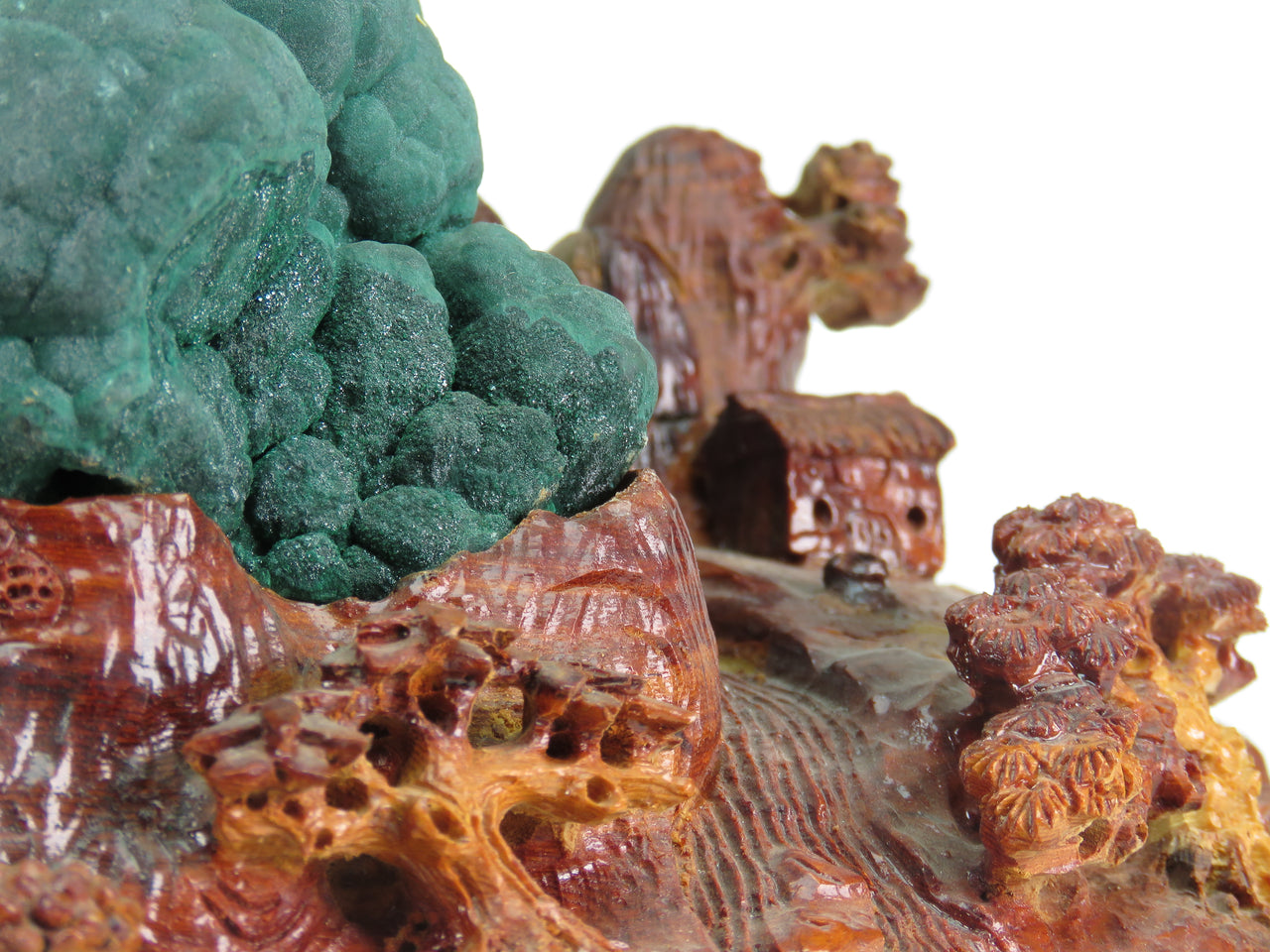 A superior malachite specimen from the Katanga region featuring classic stalactitic growth formations with lustrous, rolling surfaces reminiscent of a dramatic mountain landscape. The cabinet-sized piece from the Democratic Republic of the Congo displays exceptional quality typical of this world-class locality, elegantly mounted on a custom-carved wooden base depicting an East Asian countryside scene.