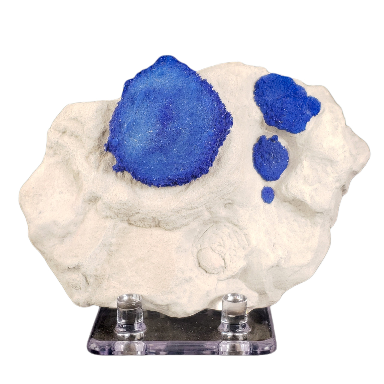 Royal blue azurite specimen featuring a large central sun formation with three smaller suns decreasing in size, arranged in an orbital pattern on white kaolinite matrix. The striking contrast and natural symmetry evoke a celestial arrangement.