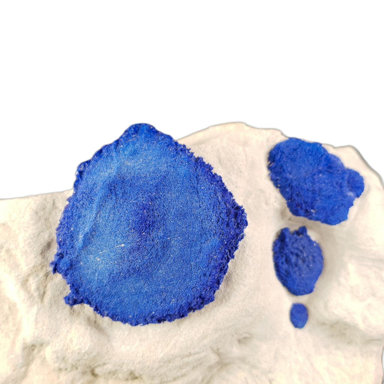 Royal blue azurite specimen featuring a large central sun formation with three smaller suns decreasing in size, arranged in an orbital pattern on white kaolinite matrix. The striking contrast and natural symmetry evoke a celestial arrangement.