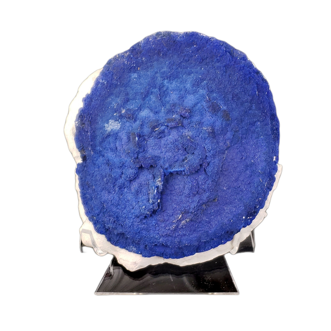 A large circular azurite formation displaying the classic 'sun' pattern, with a rich royal blue coloration and concentric textural details visible across its surface. The azurite disc sits on a thin band of white kaolinite matrix, creating a striking color contrast. The specimen shows the characteristic radiating structure typical of azurite suns, with a rough, crystalline texture across its face.