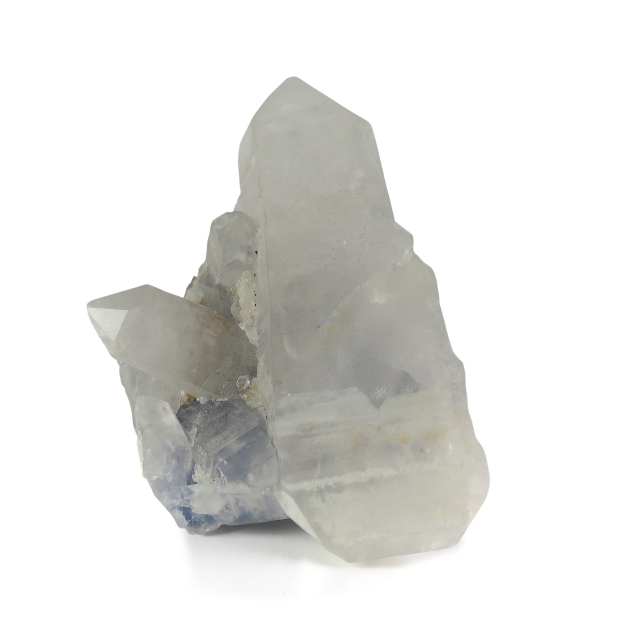 A prominent milky white quartz crystal with mixed prismatic and tabular terminations, emerging from a deep blue dumortierite-rich matrix. Smaller quartz crystals line the left side, creating a balanced composition between the lustrous white crystals and the deep blue background matrix from Brazil's Vaca Morta Quarry.